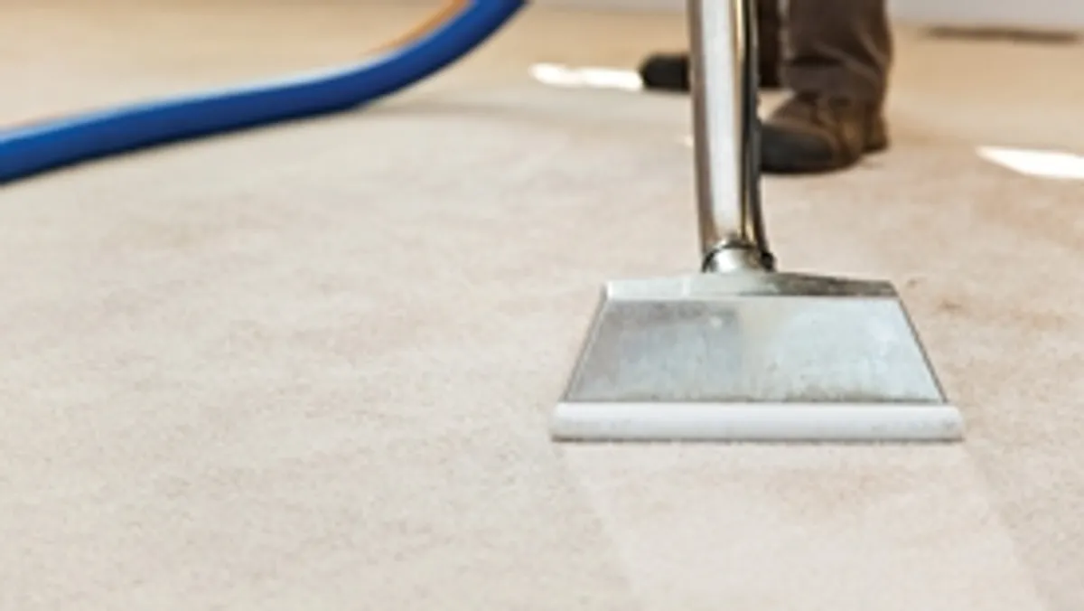 Carpet cleaning wand head gliding over a light carpet during hot-water extraction, Arlington, TX.